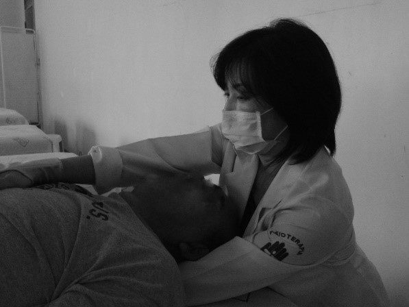 Cristina Yui aplicando terapia manual em um paciente